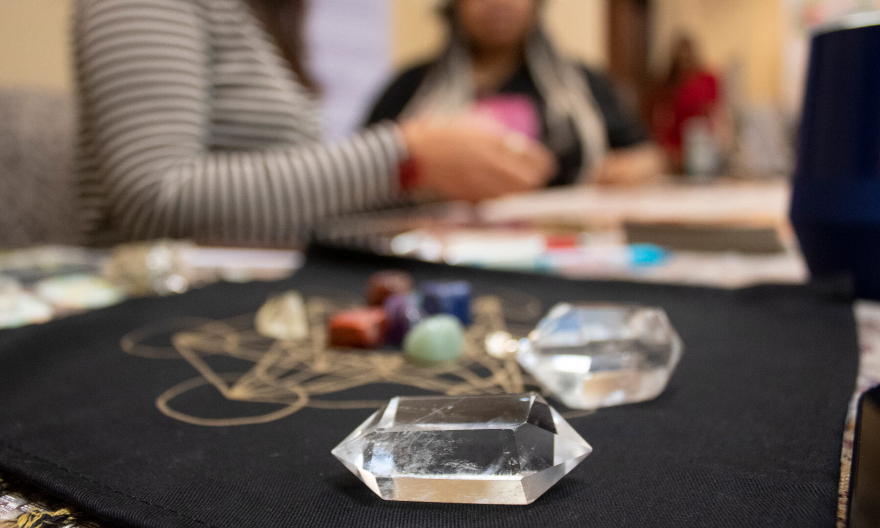 crystals with tarot reader in the background